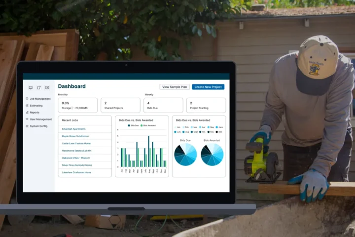 Construction worker cutting lumber with a circular saw next to a laptop displaying a construction project management dashboard.