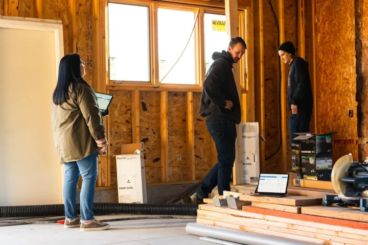 Three people in a framed home collaborating.